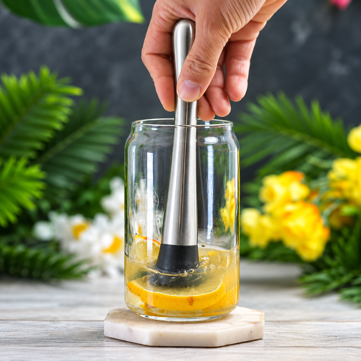 Muddling lemon slices in a glass with the stainless steel muddler
