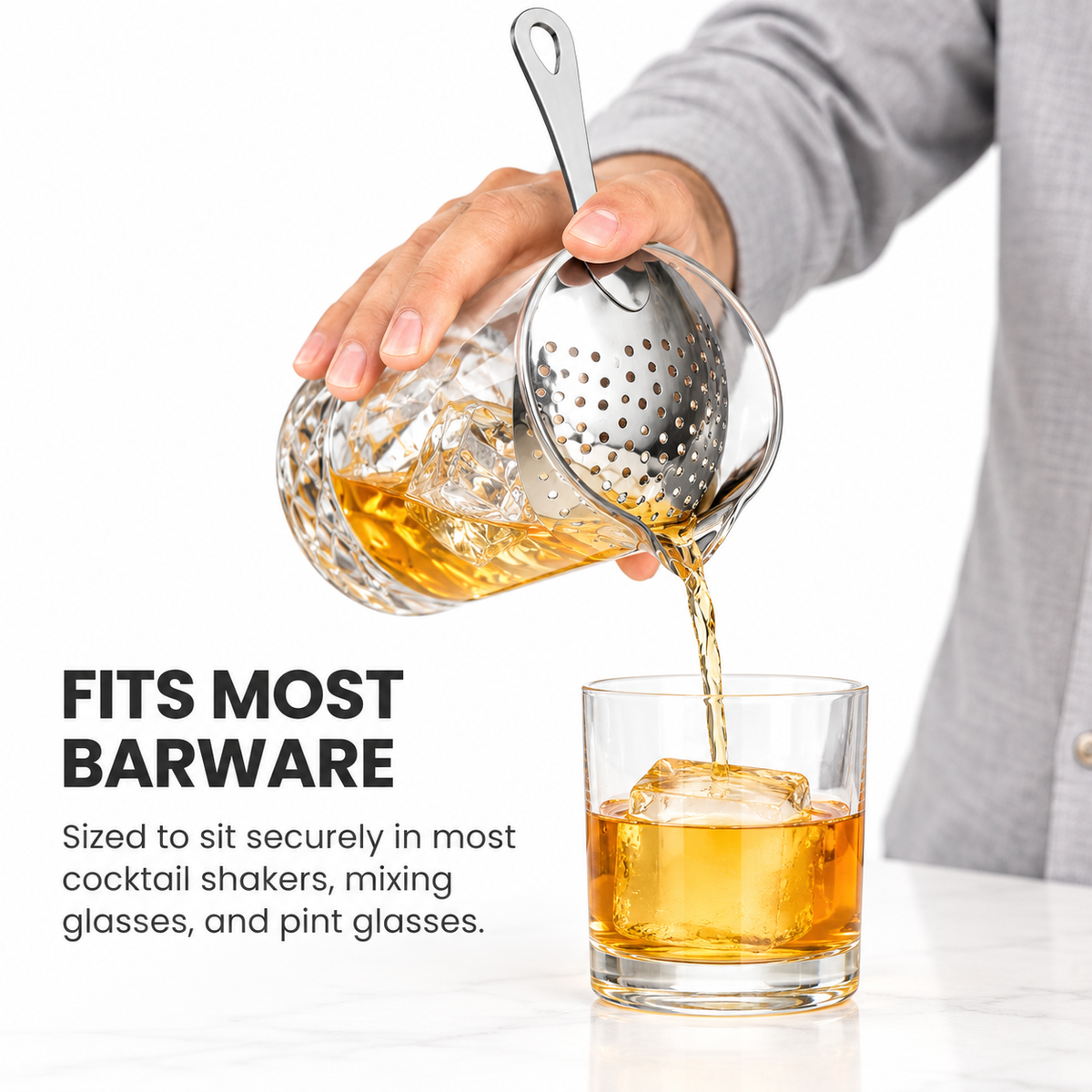 Straining a stirred cocktail from a mixing glass with a julep strainer