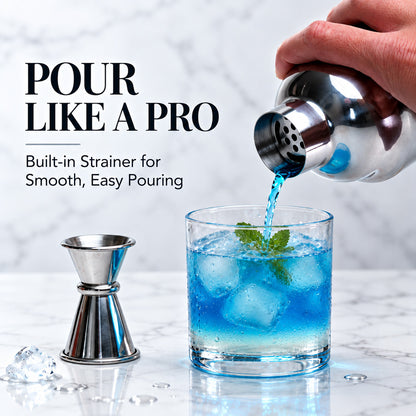 Pouring a blue cocktail through the built-in strainer of the shaker into a glass
