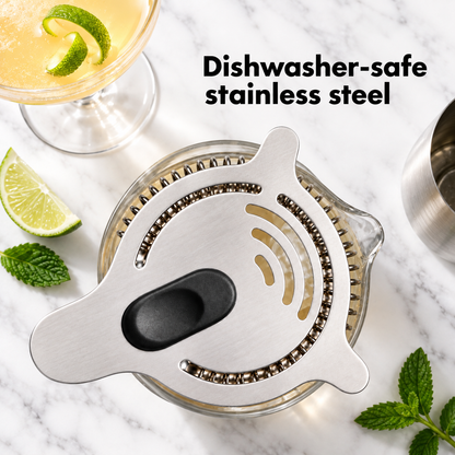 Hawthorne strainer sitting on a mixing glass with lime and mint