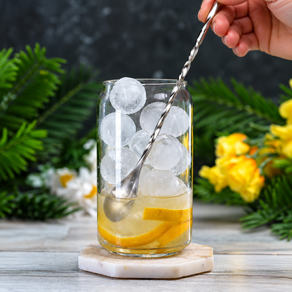 Stirring a lemon and ice drink in a glass with the twisted bar spoon
