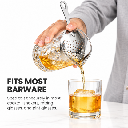 Straining a stirred cocktail from a mixing glass with a julep strainer