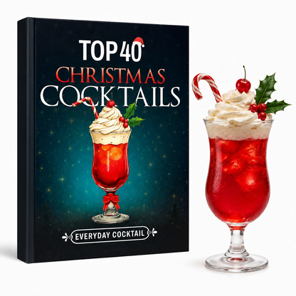 Top 40 Christmas Cocktails paperback standing beside a festive red cocktail with whipped cream and a candy cane 